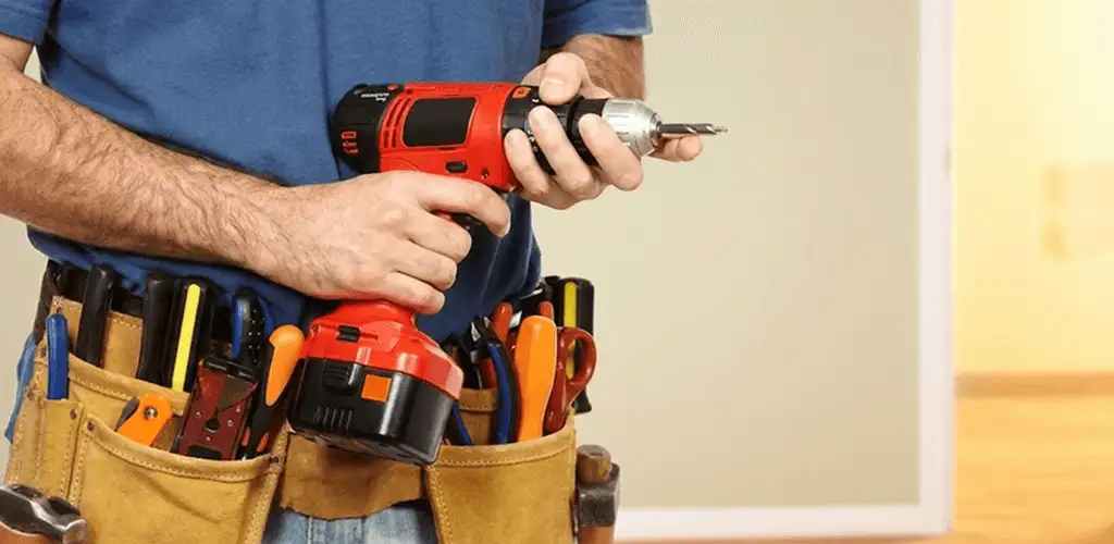 Handyman holding a power drill for home repairs and installations in Provo, UT