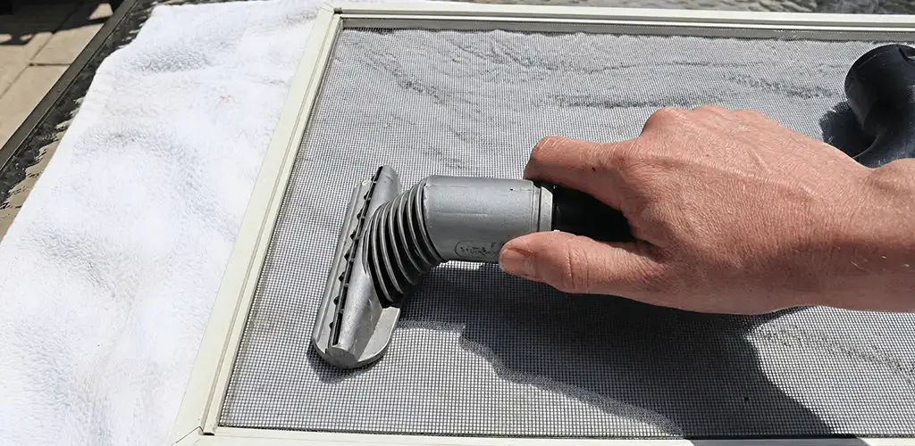 Window screen repair cleaning and fixing a damaged screen mesh in Provo, UT